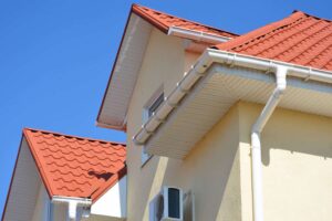 triangular shaped roof with white gutters installed on the side