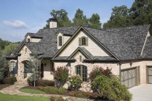 A large house with gray shingle roofing