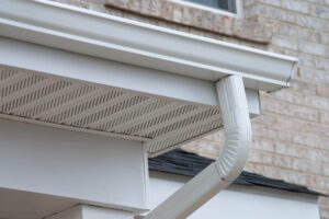 New white rain gutter on a building apartment